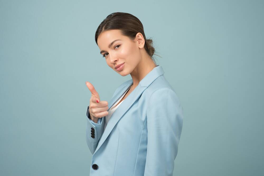 Businesswoman looking confident pointing a finger at the viewer
