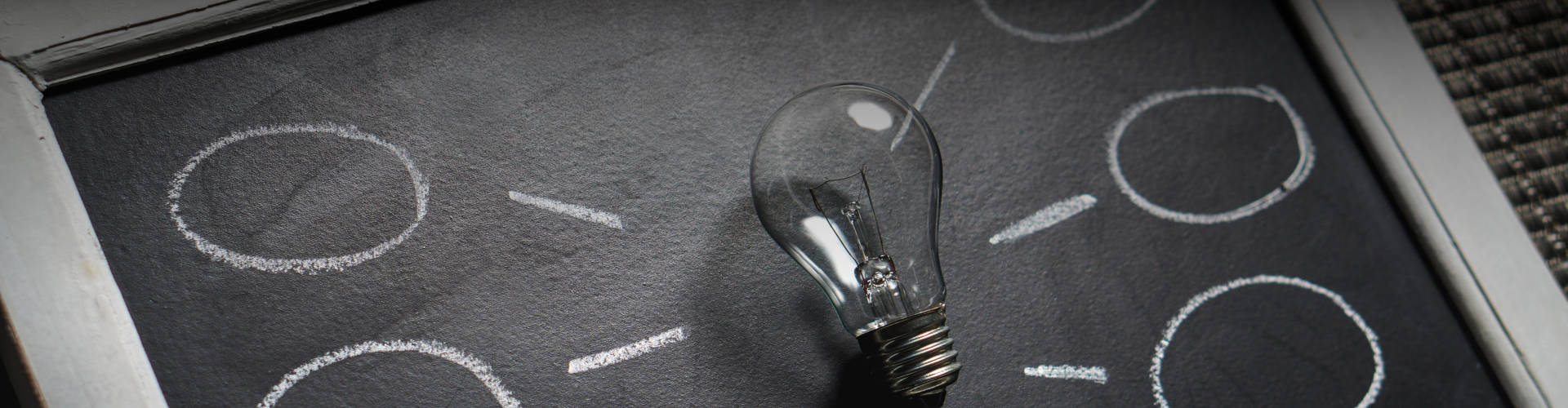 Light bulb placed on a blackboard