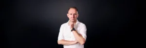 Jake Smolarek, team coaching expert, in a strategic thinking pose for his guide on building high-stakes teams.