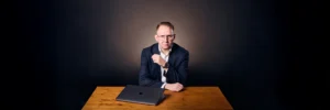 Jake Smolarek, architect of the No-Excuse Operating System, pictured at his desk for the 'What is Accountability Coaching' bible.