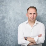 Portrait of Jake Smolarek, representing the unsentimental and direct approach of his 'What Is Career Coaching' playbook for career mastery.