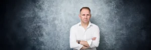 Portrait of Jake Smolarek, representing the unsentimental and direct approach of his 'What Is Career Coaching' playbook for career mastery.