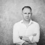 Portrait of Jake Smolarek, London-based high-performance coach, looking directly at the camera, reflecting on imposter syndrome.